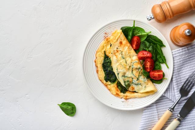 Tortilla con espinacas y tomates cherry.